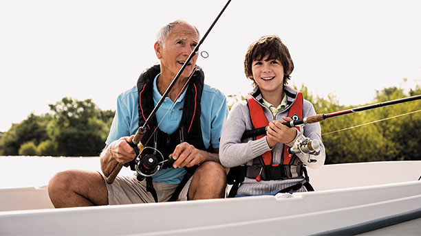 A grandfather and grandson sitting in a boat